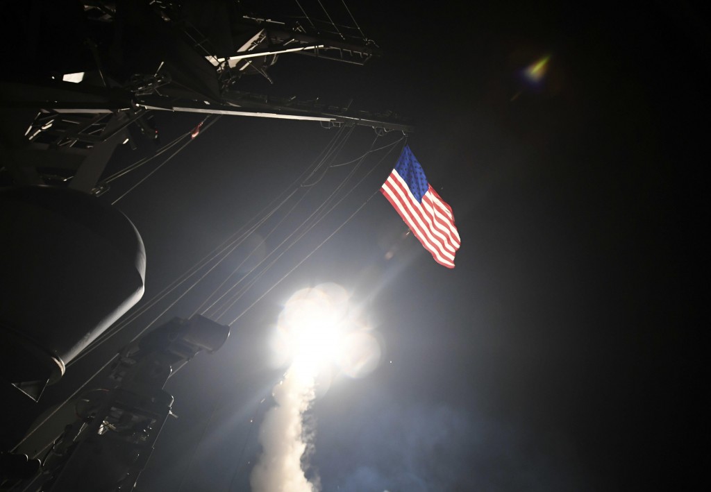 In this image provided by the U.S. Navy, the guided-missile destroyer USS Porter (DDG 78) launches a tomahawk land attack missile in the Mediterranean Sea, Friday, April 7, 2017. The United States blasted a Syrian air base with a barrage of cruise missiles in fiery retaliation for this week's gruesome chemical weapons attack against civilians. (Mass Communication Specialist 3rd Class Ford Williams/U.S. Navy via AP)